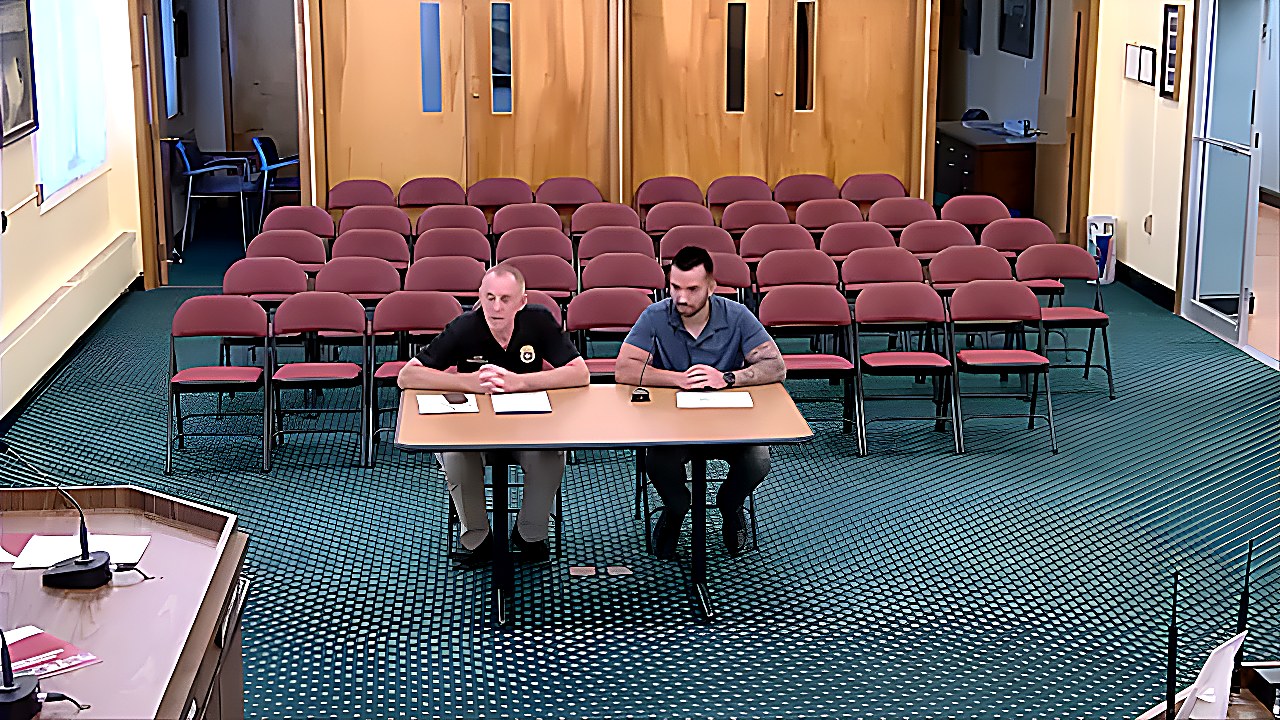 Presenters sit at the table during discussion of the authenticity of the vehicle photographs.