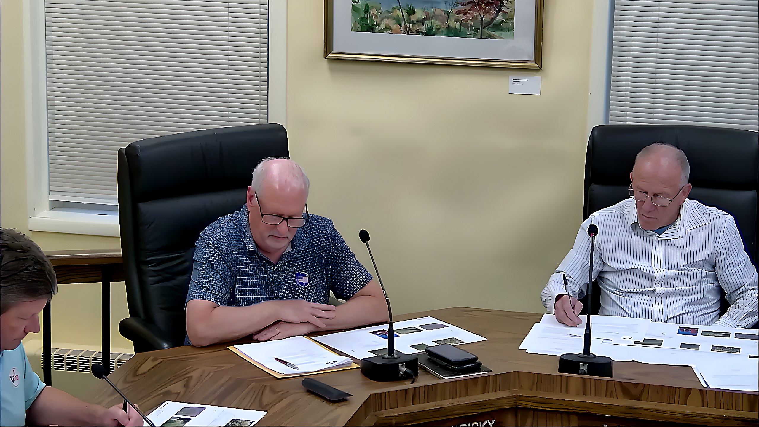 Planning Board members review documents during discussion of the amended Springcomb LLC site plan.