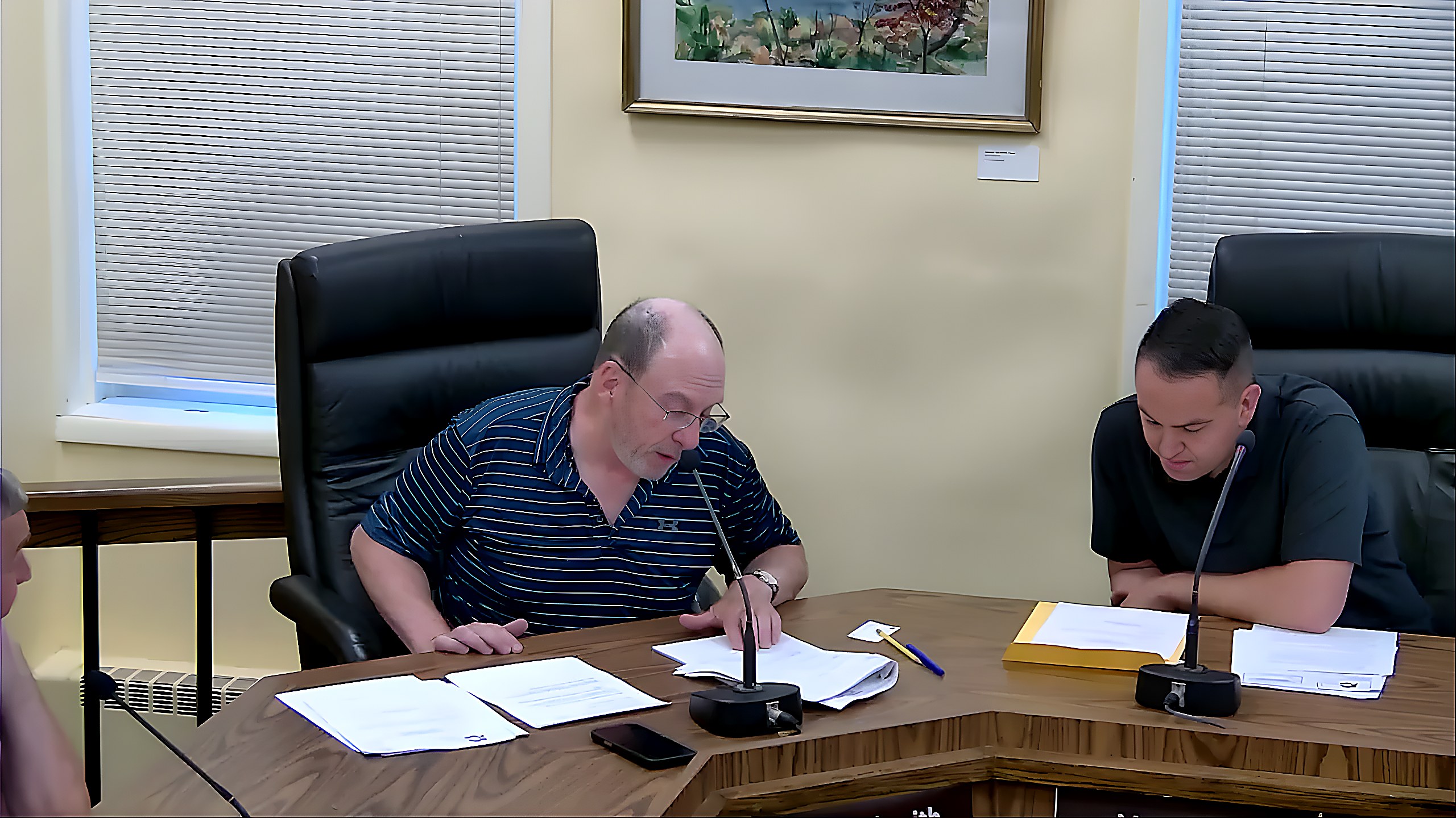 Board members review documents during discussion of the 1931 animal code's fowl and setback regulations.