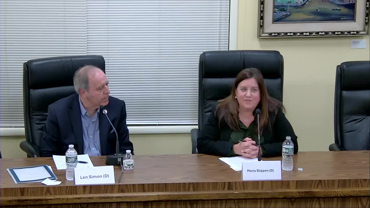 Maria Slippen discusses public trust at the October 8 LWV forum, with Len Simon seated beside her.