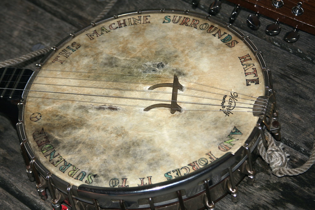 'This machine surrounds hate and forces it to surrender.' Banjo head of Pete Seeger